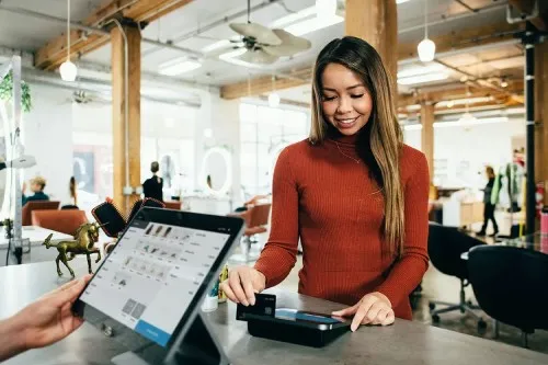A lady paying for something