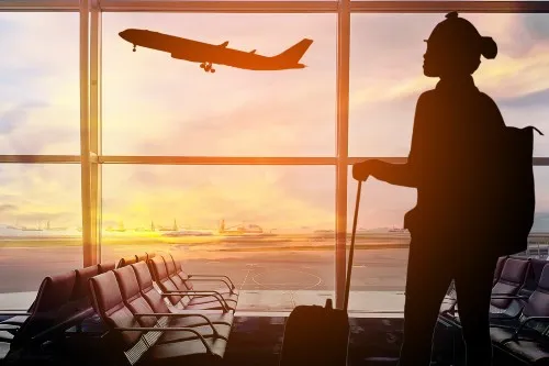 Airport lounge with sunset and a passenger
