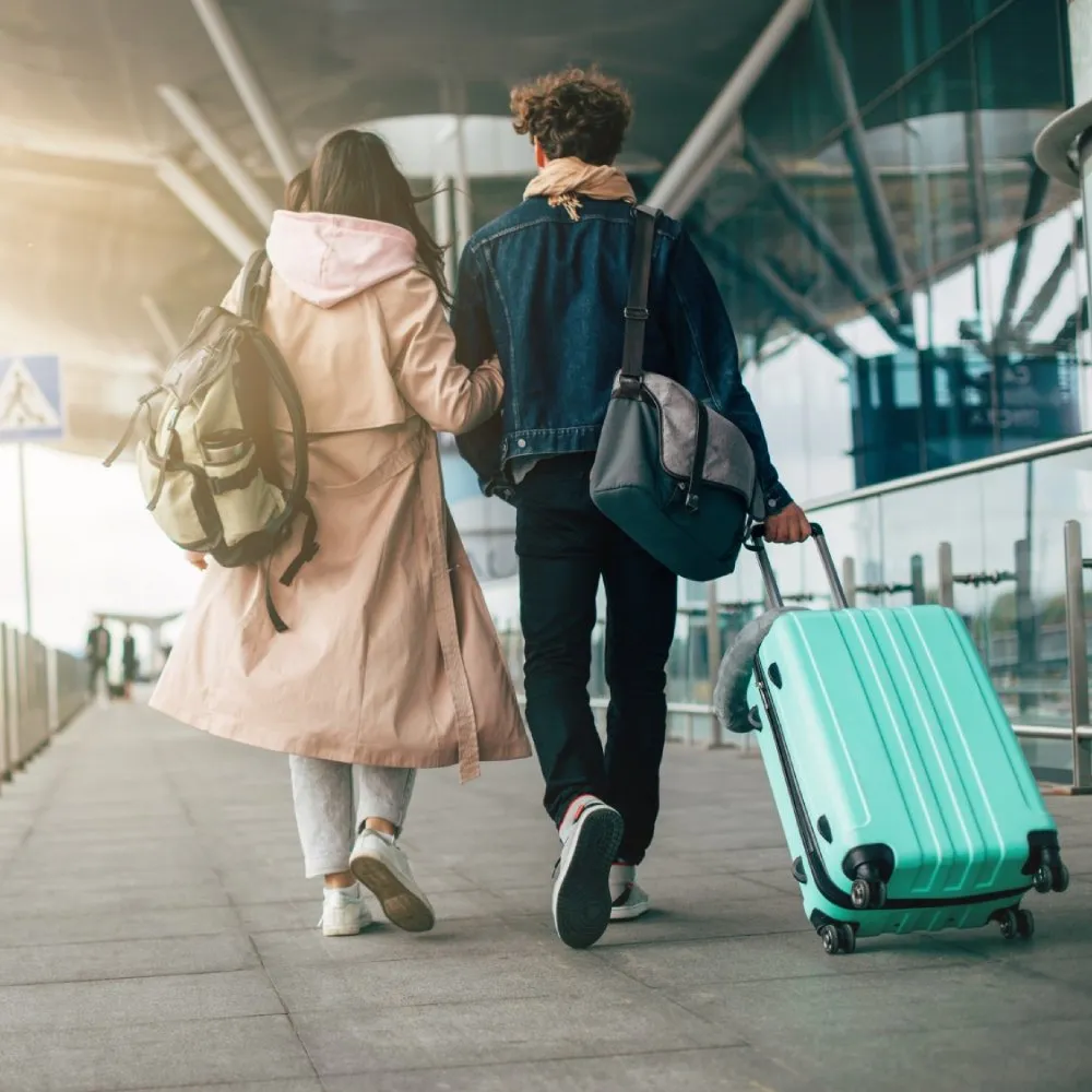 couple walking with a suitcase