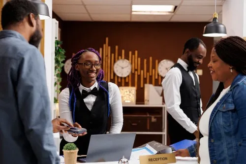 Hotel reception guests and staff